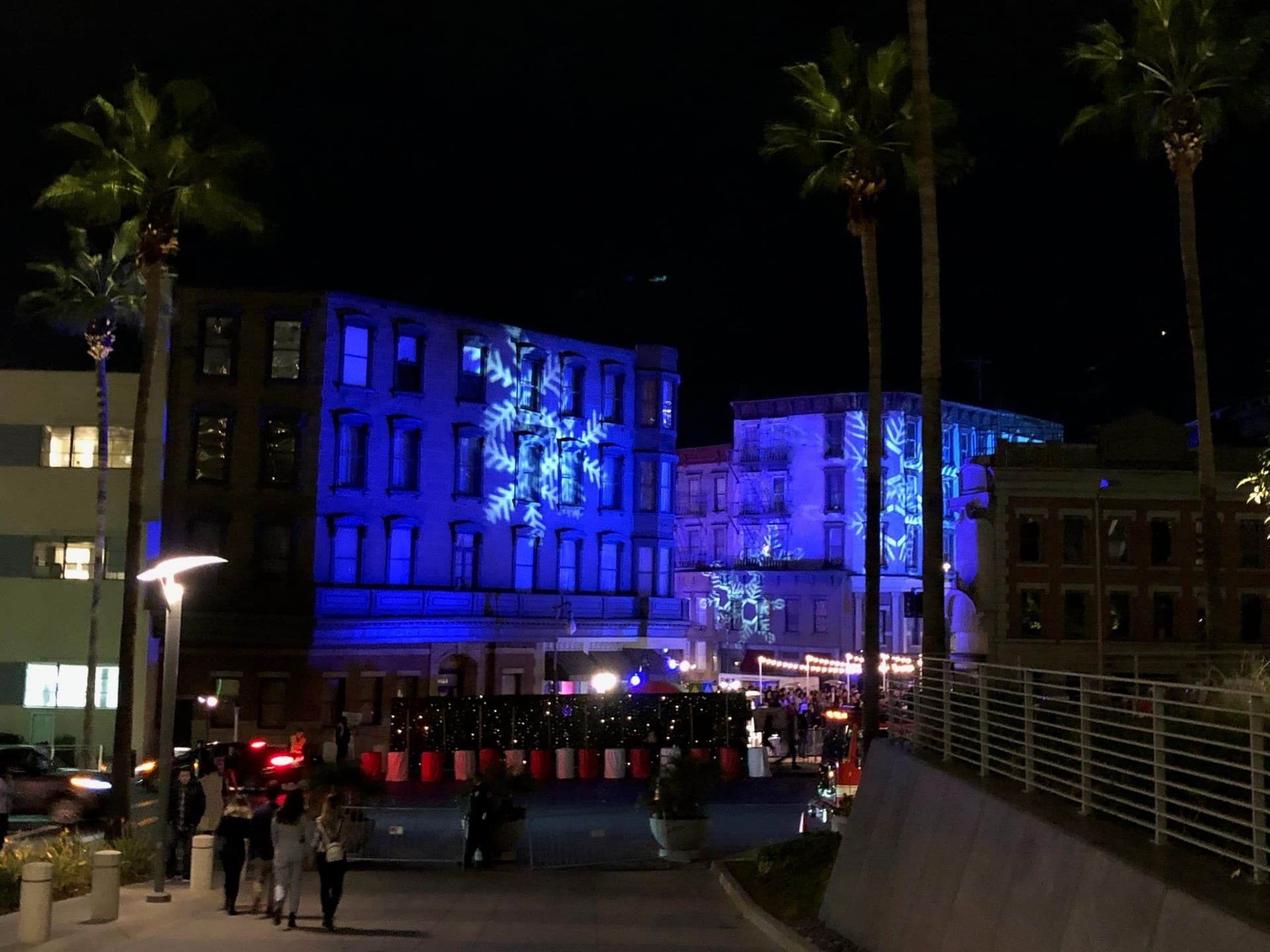 Snowflake projections across studio backlot buildings