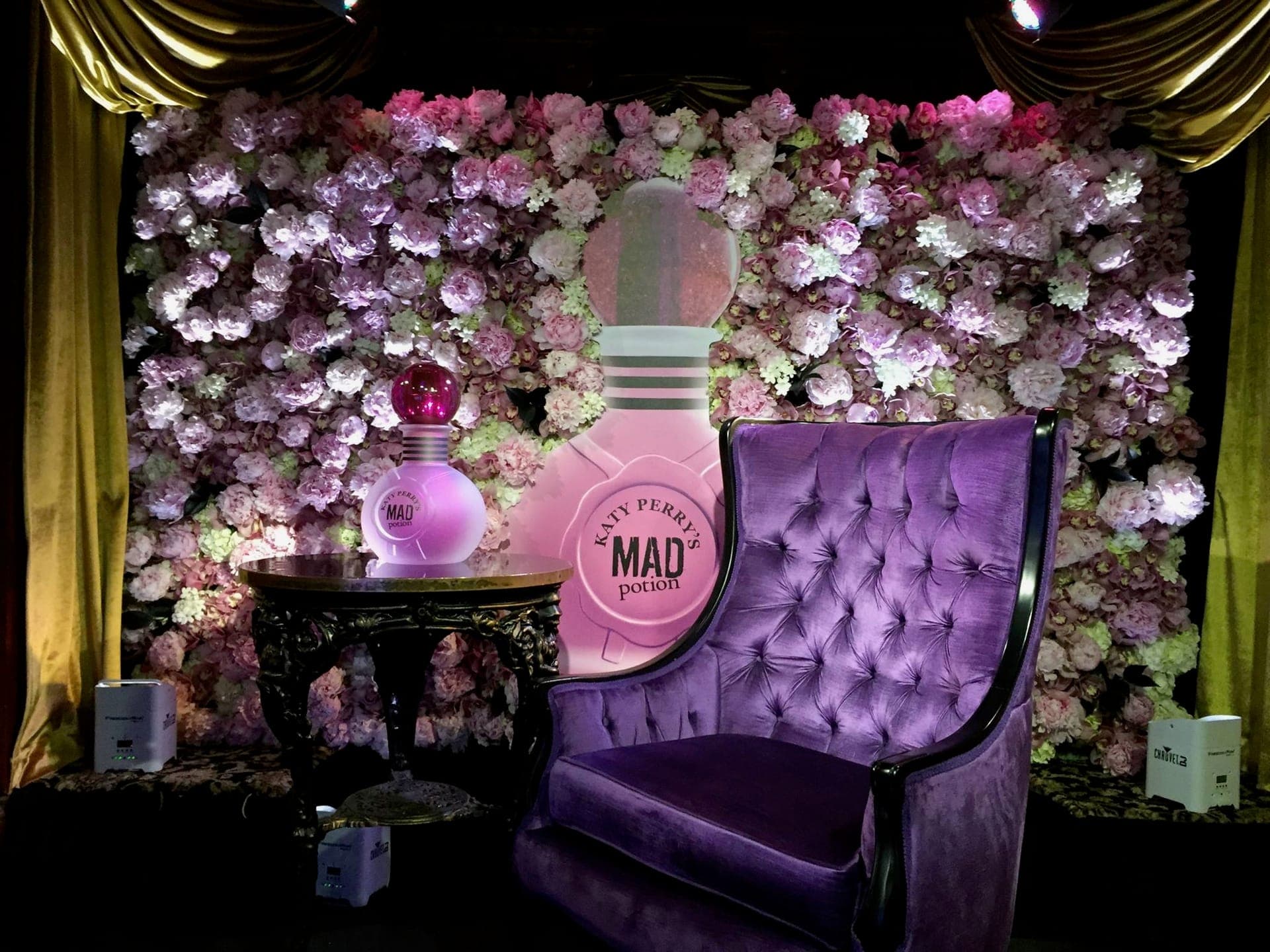 Fragrance launch vignette with flower wall and velvet chair