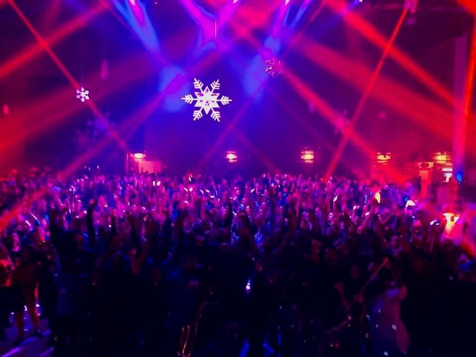 Holiday party crowd under snowflake gobos and beams of light
