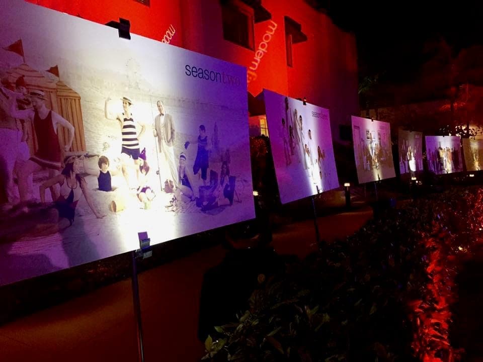 Outdoor gallery of premiere posters washed in red light