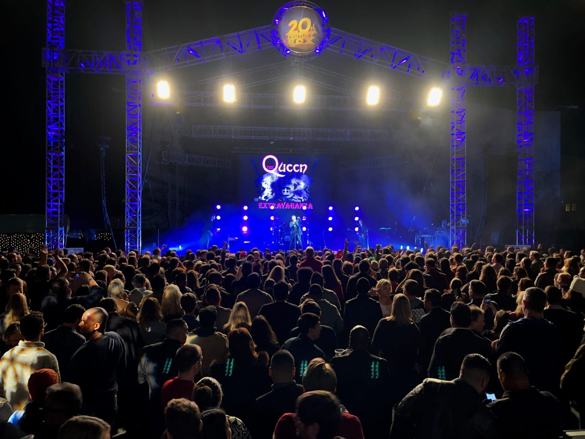 Concert stage with truss ring and moving lights before a large crowd