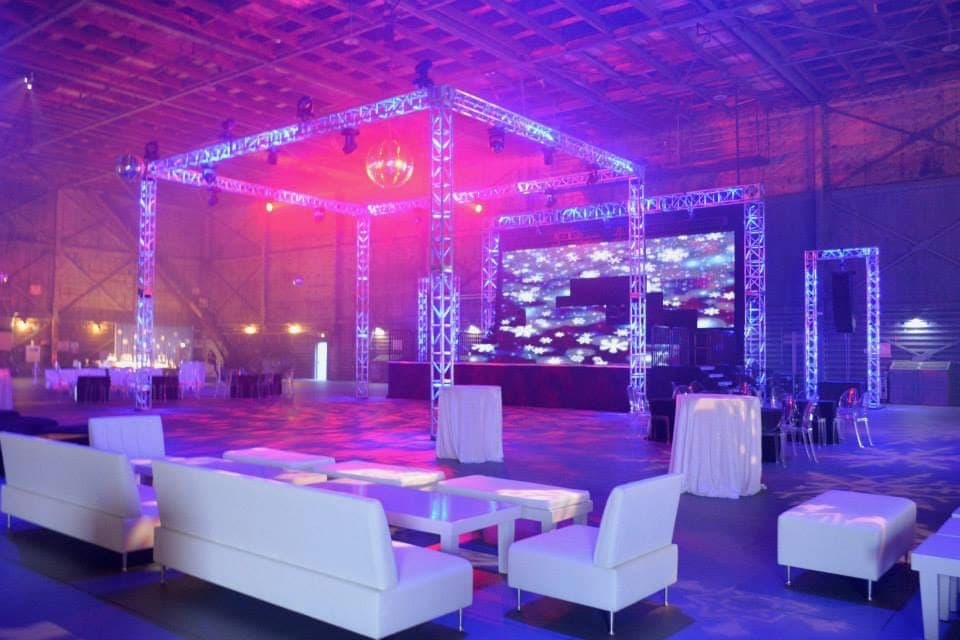 White lounge furniture before a truss and LED wall build