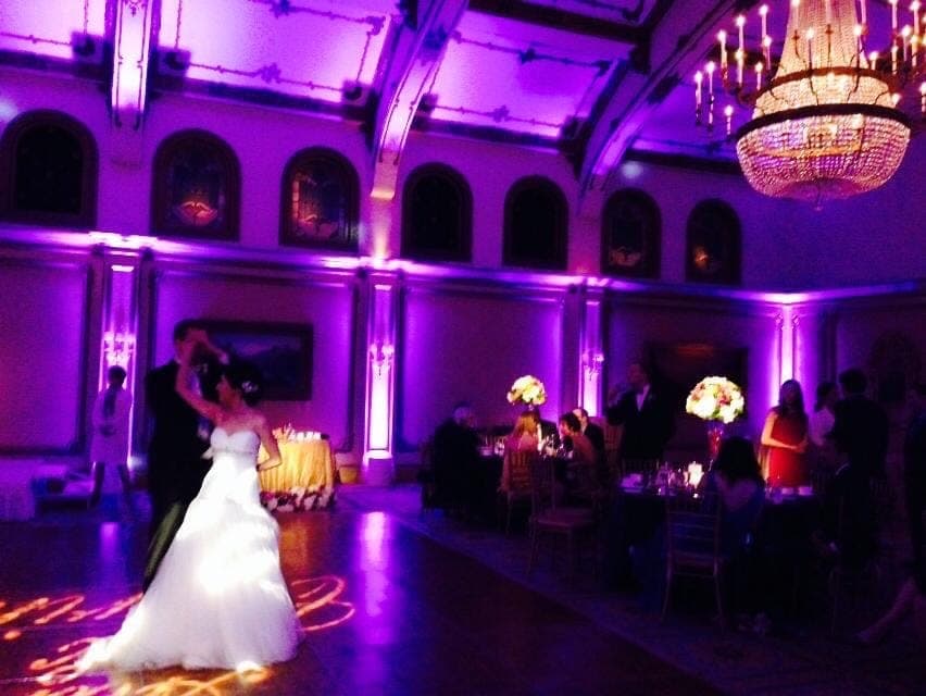 First dance in a ballroom with a monogram projected on the floor